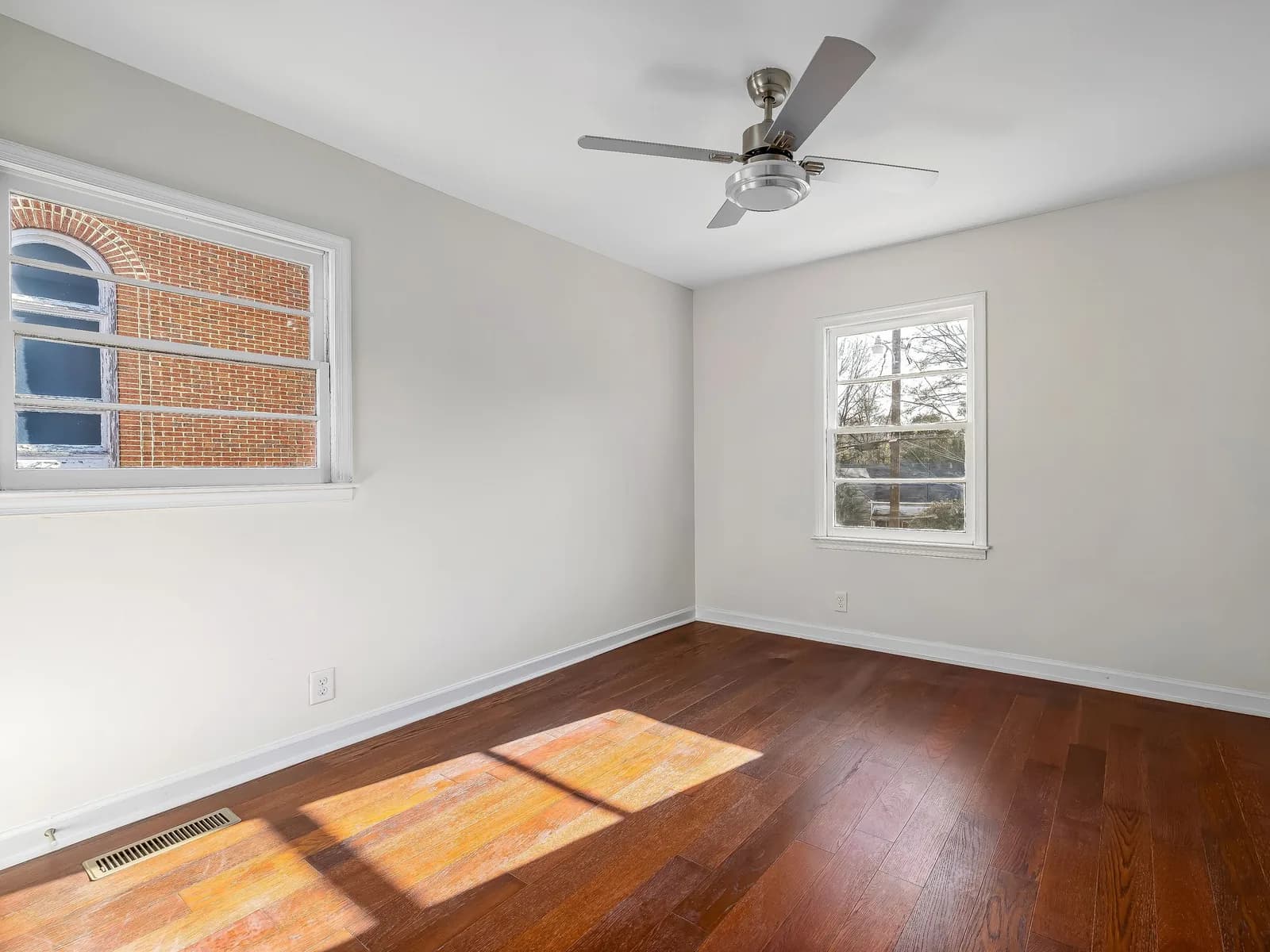 Bright newly renovated room with clean floors and finished surfaces ready for handover.